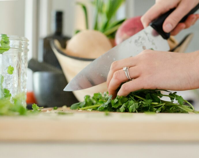 person cutting vegetables with knife