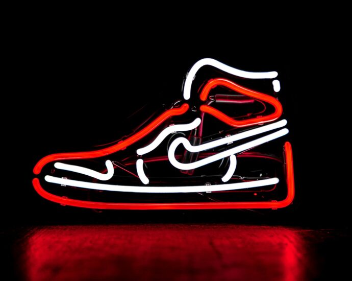 red and white Nike basketball shoe neon signage