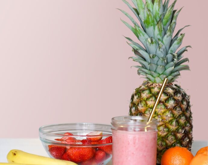 strawberry juice beside fruits on top of table