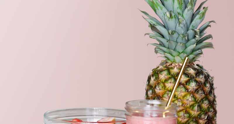 strawberry juice beside fruits on top of table